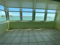 Bright sun room with tiled floor, multiple windows and panoramic water view, ideal for relaxing and enjoying the scenery at 5020 Brittany S Dr # 212, St Petersburg, FL 33715