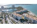 Panoramic aerial view of beachfront condos with a pool and parking, situated on a scenic waterfront at 6021 Bahia Del Mar Cir # 534, St Petersburg, FL 33715