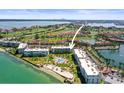 Bright aerial view shows waterfront condos with private beach and pool; great golf course nearby at 6021 Bahia Del Mar Cir # 534, St Petersburg, FL 33715