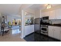 Cozy eat-in kitchen featuring stainless steel appliances, sleek countertops, and modern lighting fixtures at 750 Burlington N Ave # 4L, St Petersburg, FL 33701