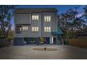 Stunning elevated three-story home with a unique coastal modern architectural style at 7500 N Ola Ave, Tampa, FL 33604