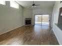 Bright living room with tile floors, fireplace, high ceilings, and sliding glass doors to the outside at 8608 Twin Farms Pl, Tampa, FL 33635