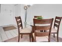 Cozy dining area featuring a round glass table with seating for four and neutral decor at 10365 Paradise Blvd # 4, Treasure Island, FL 33706
