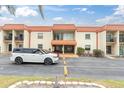 Condo exterior featuring a well-maintained facade, covered entrance, and convenient parking spaces at 10365 Paradise Blvd # 4, Treasure Island, FL 33706