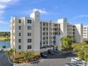 Elegant condo building exterior featuring yellow accents, multiple balconies, and well-maintained parking area at 1200 Country Club Dr # 5404, Largo, FL 33771