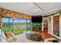 Beautifully appointed living room featuring a balcony, stone accent wall, fireplace and stylish decor at 1200 Country Club Dr # 5404, Largo, FL 33771