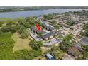 Aerial view of condos with a pool, parking, and a lake nearby at 12293 Sailwinds Dr # 206, Largo, FL 33773