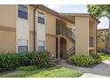 Exterior of a two-story condo building with landscaping and stairs to the second floor at 12293 Sailwinds Dr # 206, Largo, FL 33773