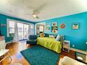 Bright living room featuring hard wood floors, daybed, and balcony access at 130 4Th N Ave # 608, St Petersburg, FL 33701