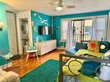 Bright living room featuring turquoise walls, hardwood floors, and comfortable contemporary furnishings at 130 4Th N Ave # 608, St Petersburg, FL 33701