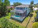Aerial view of the backyard featuring a screened pool, spa, and fenced yard at 13310 Waterford Run Dr, Riverview, FL 33569