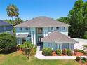 Inviting two-story home showcasing lush landscaping and manicured lawn at 13310 Waterford Run Dr, Riverview, FL 33569