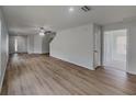 Bright living room with new wood floors and modern ceiling fan at 15411 Quail Woods Pl, Ruskin, FL 33573