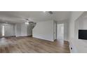 Bright living room with new wood floors and modern ceiling fan at 15411 Quail Woods Pl, Ruskin, FL 33573