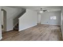 Spacious living room featuring beautiful floors and a staircase at 15411 Quail Woods Pl, Ruskin, FL 33573