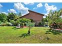 Charming home exterior with lush landscaping, vibrant green lawn, and inviting curb appeal at 17301 Estes Rd, Lutz, FL 33548
