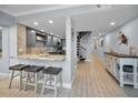 Open-concept kitchen with barstool seating and an inviting hallway at 19700 Gulf Blvd # 403, Indian Shores, FL 33785