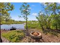 Inviting backyard firepit and lake view offers a tranquil outdoor setting for relaxation and entertaining at 19924 Dolores Ann Ct, Lutz, FL 33549