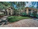 Lush front lawn with mature palms and plantings enhance this spacious, bright single Gathering home at 20 Willowwood Ln, Oldsmar, FL 34677