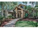 Attractive home featuring unique architectural details and mature landscaping around the grounds at 20 Willowwood Ln, Oldsmar, FL 34677