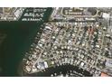 An aerial view shows the neighborhood featuring waterfront properties and a marina at 2488 Del Rio Way, Dunedin, FL 34698