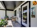 Inviting front porch with stylish decor, comfortable seating, and clear house number display at 2488 Del Rio Way, Dunedin, FL 34698