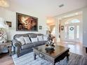 Comfortable living room with a luxurious leather couch and a decorative lion artwork above at 3625 Gaviota Dr, Ruskin, FL 33573