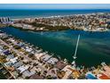 Aerial view of waterfront homes with docks and boat lifts on canal leading to the Gulf of Mexico at 366 La Hacienda Dr, Indian Rocks Beach, FL 33785