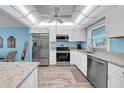 Well-equipped kitchen with stainless steel appliances, island, and white cabinets promotes culinary creativity at 4725 Cove Cir # 302, St Petersburg, FL 33708