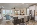 Open concept kitchen with center island, stainless appliances, and waterfront views at 600 Reserve Ln, Dunedin, FL 34698