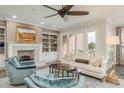 Cozy living room features a fireplace, built-in bookshelves, and access to a private balcony at 600 Reserve Ln, Dunedin, FL 34698