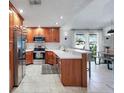 Bright kitchen with stainless steel appliances and breakfast bar seating at 6262 142Nd N Ave # 1106, Clearwater, FL 33760