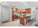 Charming kitchen featuring wood cabinets and bar stool seating at 6262 142Nd N Ave # 1106, Clearwater, FL 33760