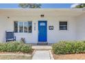 A close up on the front door with a beautiful blue finish and decorative glass at 9100 2Nd N St, St Petersburg, FL 33702