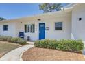 Nice single-story home with fresh exterior paint, neatly maintained landscaping, and a vibrant blue front door at 9100 2Nd N St, St Petersburg, FL 33702
