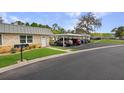 Well-maintained condo exterior with stone accents, lawn, and covered parking in a desirable community at 11728 Carissa Ln # 0, New Port Richey, FL 34654