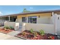 Cozy condo with a private entrance, landscaping, and neutral tones at 1203 16Th Se Cir, Largo, FL 33771