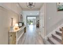 Light-filled foyer featuring stylish wood-look flooring and staircase at 13042 Pennybrook Dr, Riverview, FL 33579
