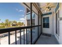 Cozy screened lanai with a ceiling fan, offering a relaxing outdoor space with neighborhood views at 171 Medallion Blvd # F, Madeira Beach, FL 33708