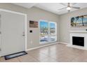 Bright living room features neutral walls, tile flooring, and a decorative fireplace at 171 Medallion Blvd # F, Madeira Beach, FL 33708