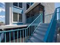 This stairway has blue railings and leads to a private entrance with access to a screened lanai at 171 Medallion Blvd # F, Madeira Beach, FL 33708