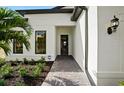 Inviting front entrance with a beautifully landscaped walkway leading to the decorative front door at 17921 Nadine Pl, Nokomis, FL 34275