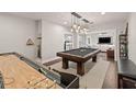 Spacious game room includes a billiards table and shuffleboard, with easy access to living area at 19810 Prince Benjamin Dr, Lutz, FL 33549