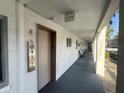 Hallway with an elevator, white walls, exterior windows, and chairs for residents at 2077 Canal Dr # L35, Bradenton, FL 34207