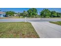 A view of the property from the street, with a glimpse of the surrounding neighborhood at 2344 Pleasant Hill Ln, Holiday, FL 34691