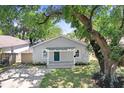 Inviting single-story home with a shady tree in the front yard offering curb appeal at 2415 E 20Th Ave, Tampa, FL 33605