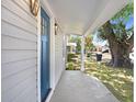 A welcoming front porch with a blue front door and fresh neutral colored siding at 2415 E 20Th Ave, Tampa, FL 33605