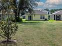 Spacious backyard with a well-maintained lawn and a view of neighboring homes, perfect for outdoor activities at 3686 Zephyr Preserve Pl, Zephyrhills, FL 33541