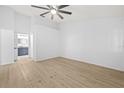 Spacious bedroom with new flooring and an open view to the ensuite bathroom at 5482 Salem Square N Dr, Palm Harbor, FL 34685