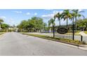 View of the Devonshire neighborhood entrance, showcasing manicured landscaping and a decorative fountain at 5482 Salem Square N Dr, Palm Harbor, FL 34685